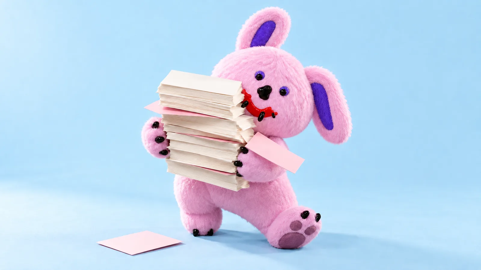 Draki hugs a stack of blank cream and pink cards as one slips onto the pale blue floor.